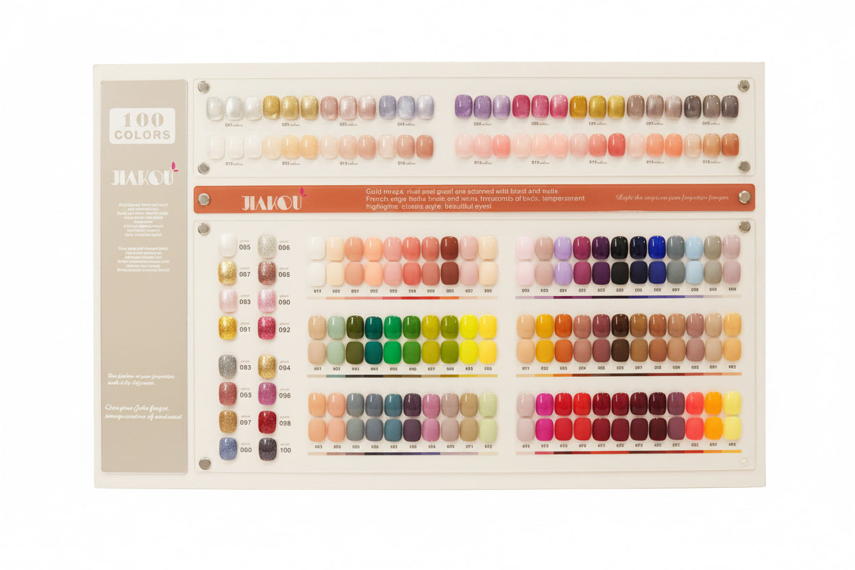 A large JACU nail polish color display board showing 100 color options arranged in rows, photographed on a tabletop with a warm indoor background.