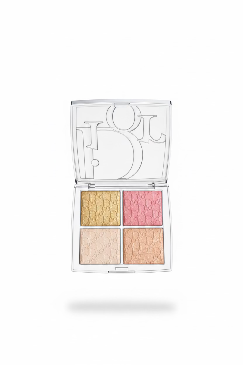 A hand holding an open Dior 4-pan eyeshadow palette. The clear plastic case features a large silver-tone Dior logo on the inside of the lid, and the four eyeshadow pans are arranged in a grid with gold, pink, champagne, and peach tones, all embossed with the Dior Oblique pattern.