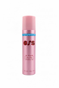 A pink cylindrical bottle of O/S On 'Til Dawn Waterproof Setting Spray standing on a counter in a retail store with shelves of other products in the background.