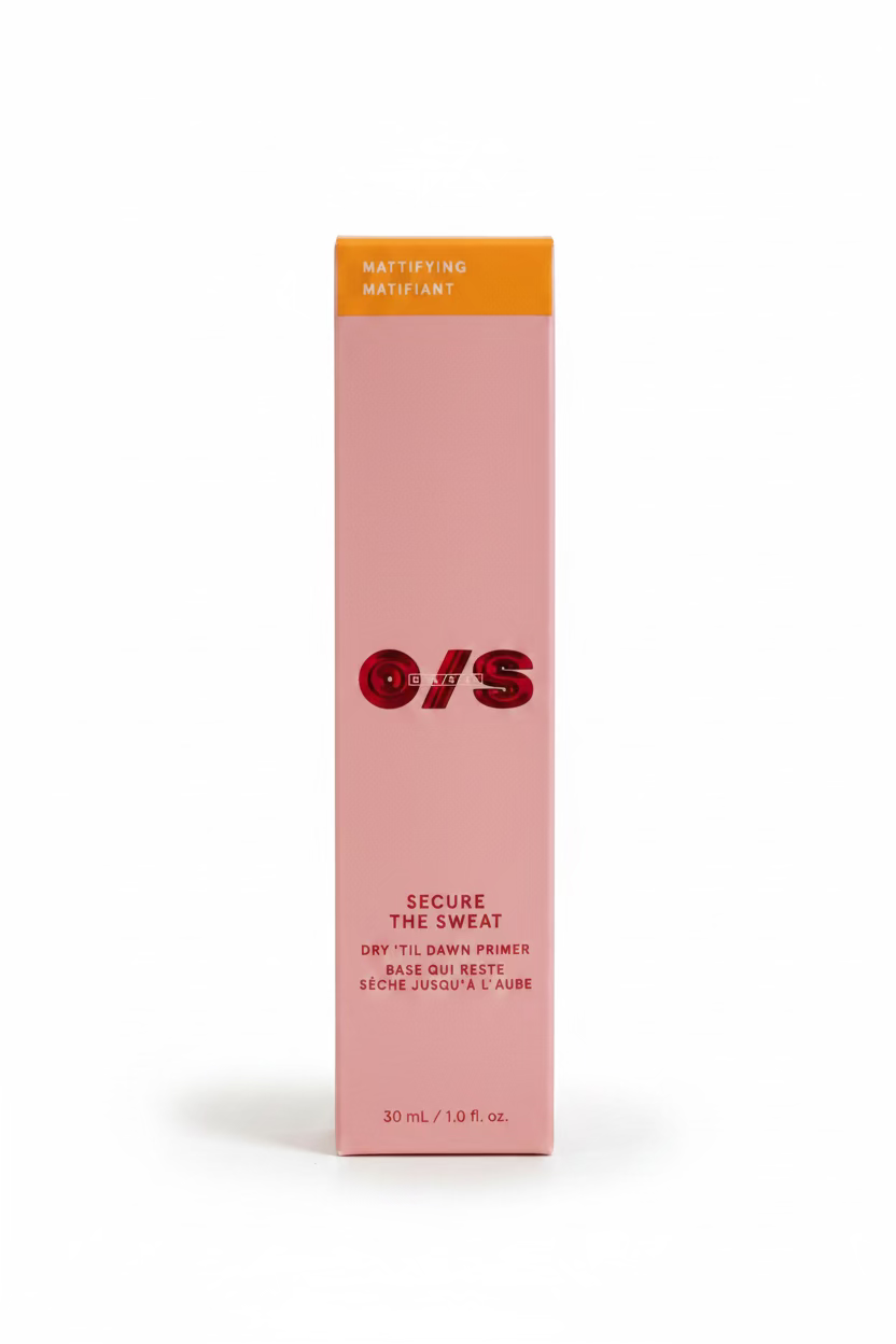 A pink rectangular box of O/S Secure the Sweat Mattifying Matifiant dry till dawn primer, displayed on a glass counter inside a retail store with shelves of other products in the background.