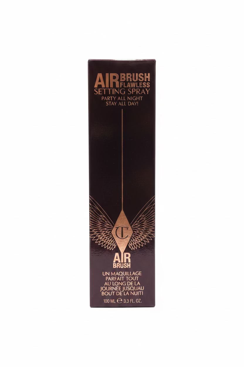 A tall black box of AIRBRUSH Airbrush Flawless Setting Spray standing on a glass display shelf, surrounded by other cosmetic boxes in a store.