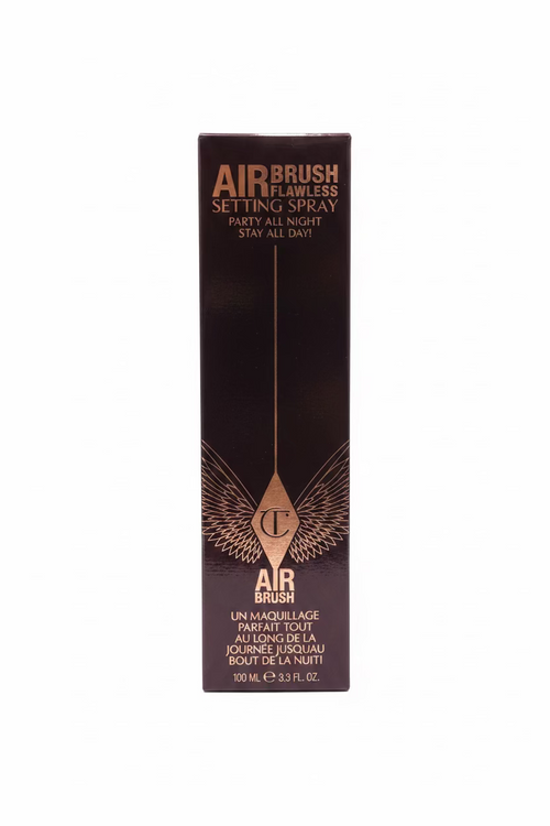 A tall black box of AIRBRUSH Airbrush Flawless Setting Spray standing on a glass display shelf, surrounded by other cosmetic boxes in a store.