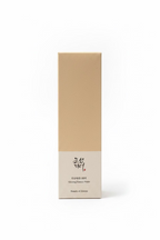 A tall rectangular box of Beauty of Joseon Ginseng Essence Water standing on a glass display shelf, with other cosmetic boxes blurred in the background.