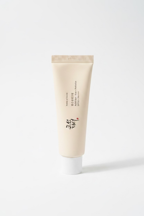 A beige cosmetic tube labeled 'Beauty of Joseon' and 'Probiotics SPF 30+' stands on a reflective glass counter in a retail setting, with product boxes and shelves visible in the background.