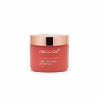 A jar of mec.cube Collagen Jelly Cream placed on a glass display shelf in a retail store, with a blurred shop interior and a person visible in the background.
