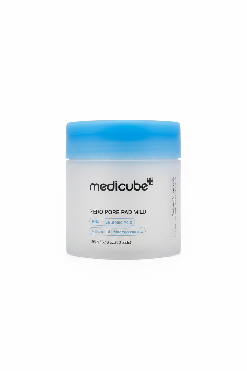 A jar of medicube Zero Pore Pad Mild skincare pads, featuring a frosted white container and a bright blue lid, displayed on a glass shelf in a retail setting.
