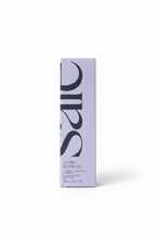 A tall rectangular box of SCF Glowy Super Gel moisturizer standing on a glass counter in a retail store. The box is light lavender with large black SCF lettering and product text near the bottom.
