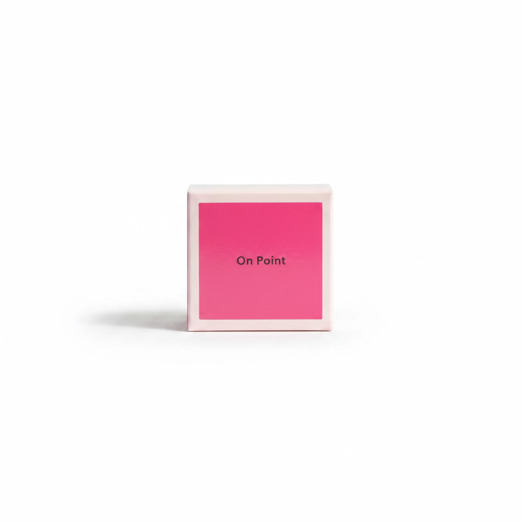 A hand holding a small square pink box with the words 'On Point' printed on the front, set against a background of blue denim clothing.