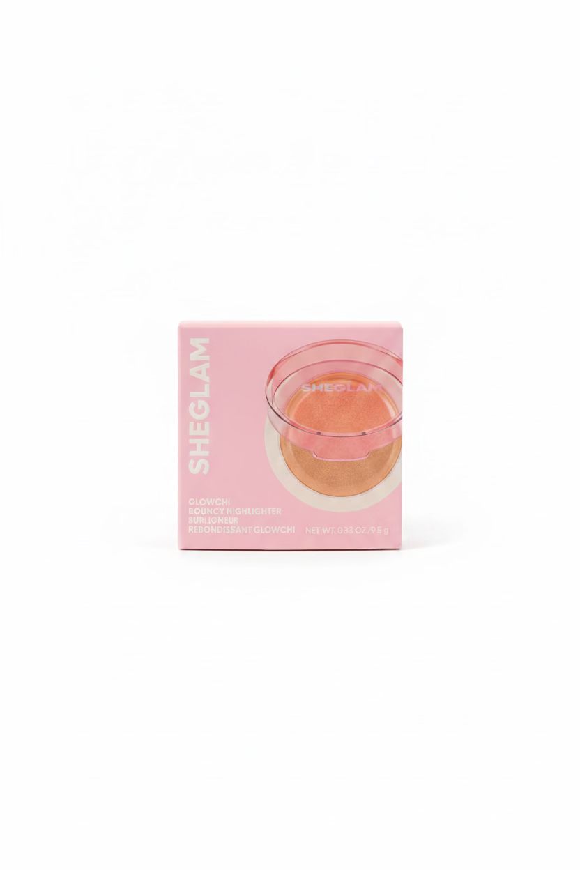 A pink box of SHEGLAM Gloworch Source Highlighter powder sits on a glass display shelf in a retail store. The packaging features a pink glow-in-the-dark glass cup illustration showing the product's effect.