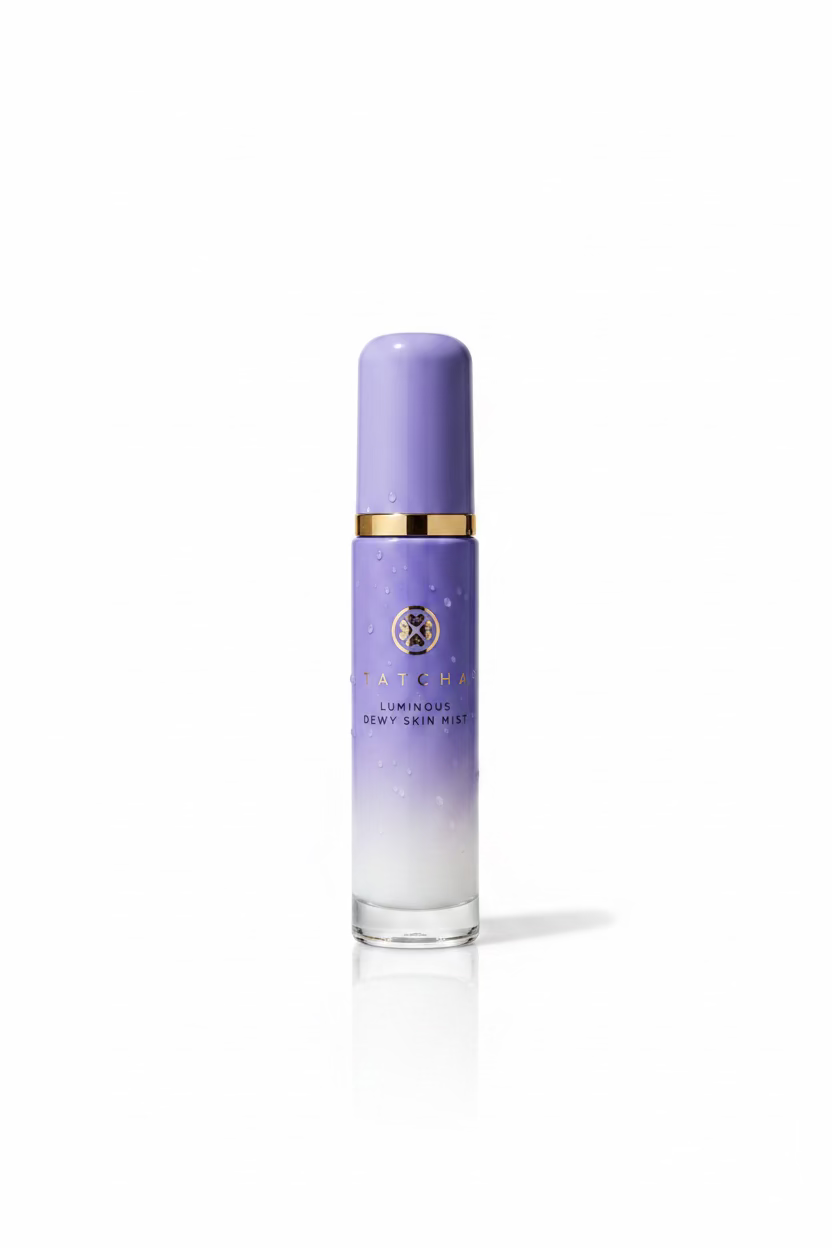 A bottle of Atojus Luminous Dry Skin Mist with a purple-to-white gradient cap and body, standing on a reflective glass counter inside a retail store.