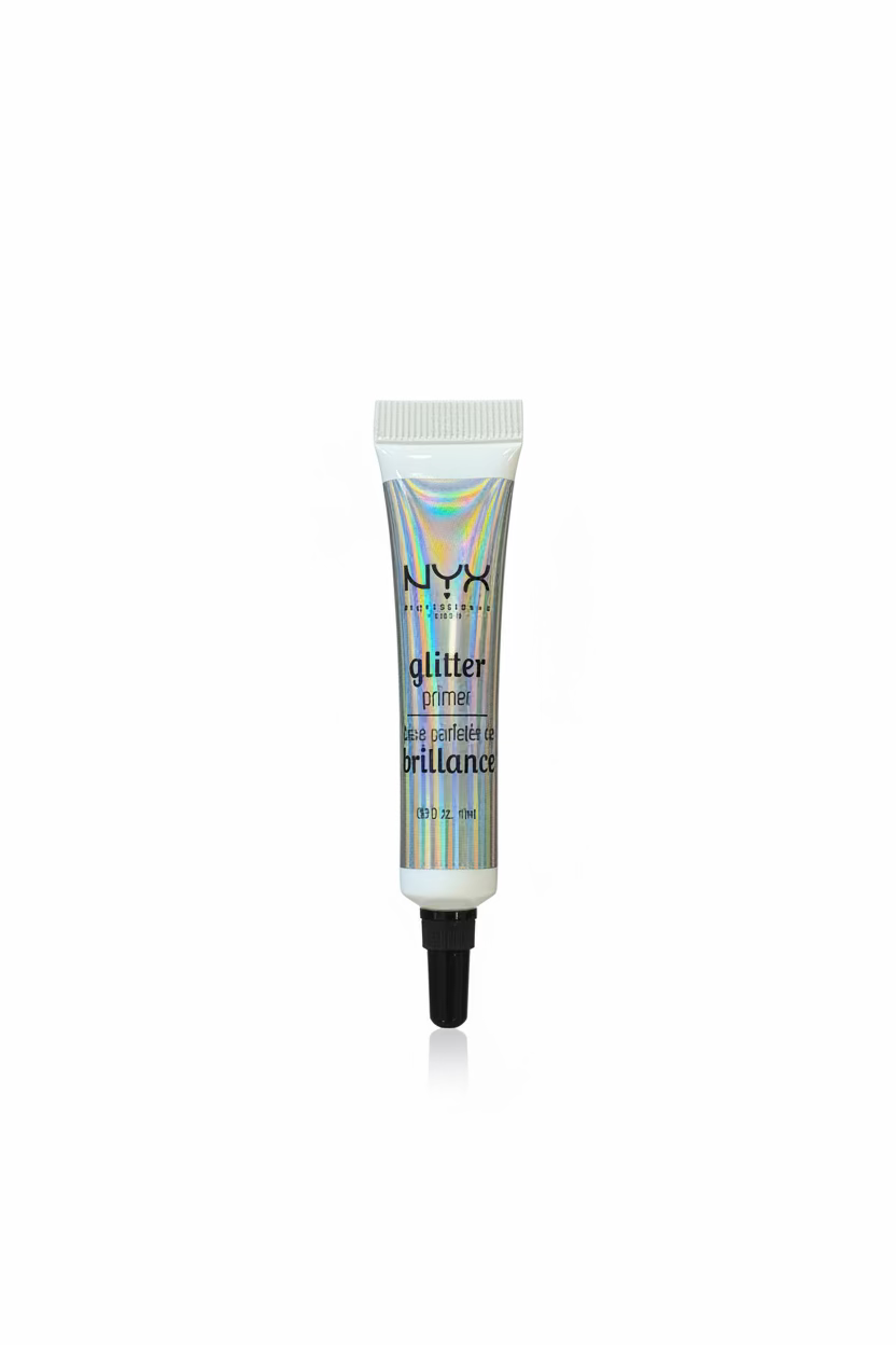 A hand holding a tube of NYX Glitter Illusion nail polish powder, showing the holographic silver packaging and black applicator tip against a background of a shop shelf.
