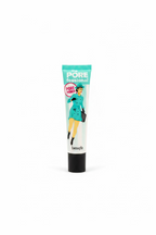 Benefit The Pore Fessional Pore Primer in a squeeze tube, standing on a glass display counter inside a retail cosmetics store.