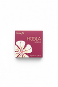 A hand holding a Benefit Hoola Original makeup compact in its original magenta packaging, with a hibiscus flower graphic on the front.