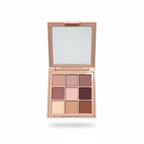 A person's hand holds an open 9-shade eyeshadow palette with a mirror in the lid. The palette is a dusty pink color, and the eyeshadow shades range from light pink and beige to mauve, plum, and terracotta.