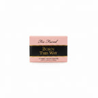 Too Faced Born This Way Effortless Makeup Primer box in pink and black packaging, shown on a glass display counter in a store.