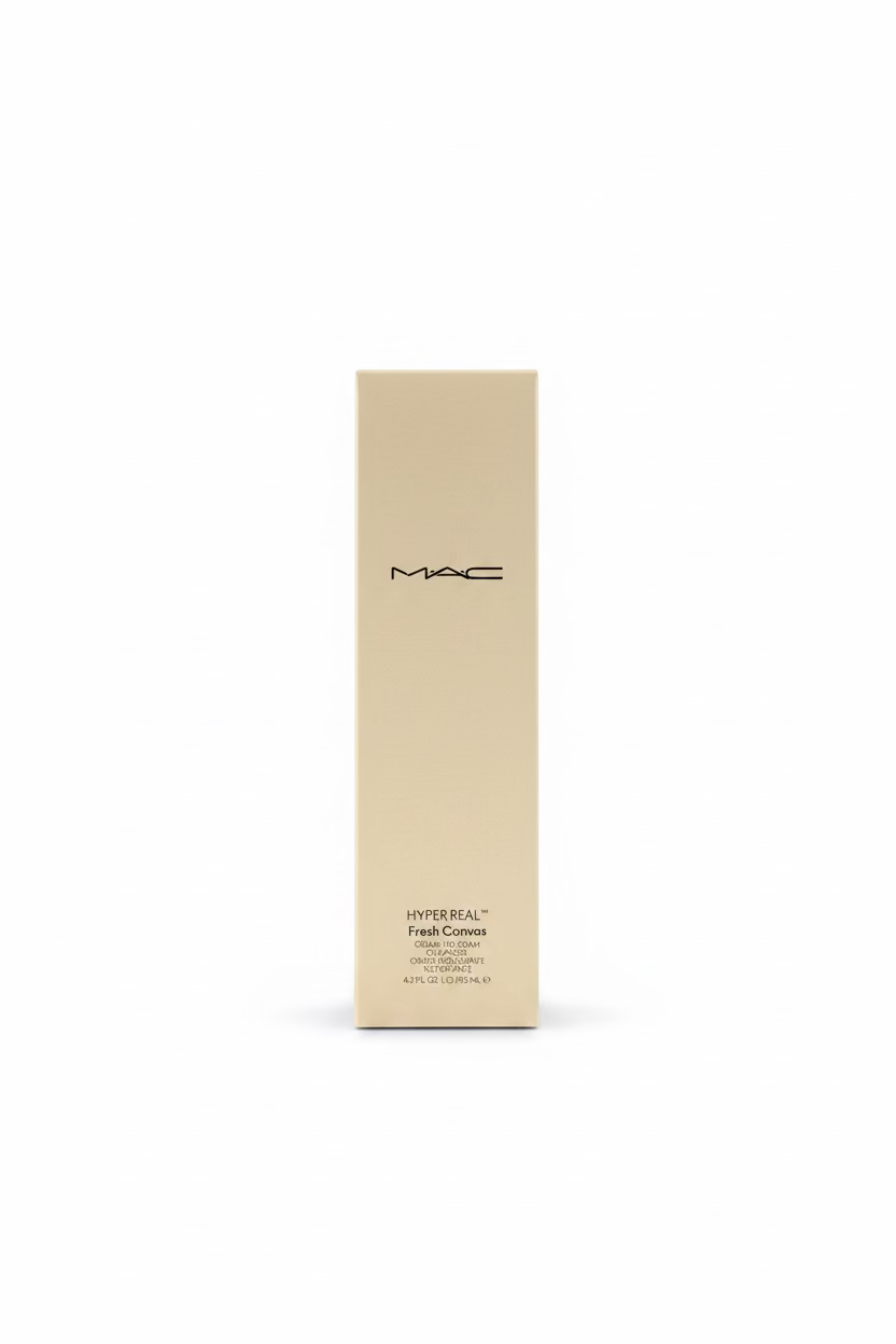 A tall beige MAC Hyper Real Faux Curls product box standing upright on a glass display counter inside a cosmetics store. A laptop is visible on the left and shelves of haircare products are in the background.