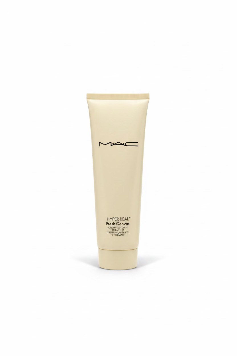 A tube of MAC Hyper Real Fresh Convex Cleanser standing on a glass counter inside a retail store, with a laptop and shelves of cosmetics in the background.