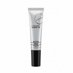 A silver and black tube of MAC Studio Fix Matifying Shine-Control Primer standing on a glass display counter inside a retail store.