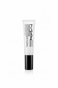 A tube of MAC Studio Radiance Moisturizing Silk Primer standing upright on a glass display counter inside a retail store. The product tube is white with black text and a black cap, with MAC branding clearly visible.