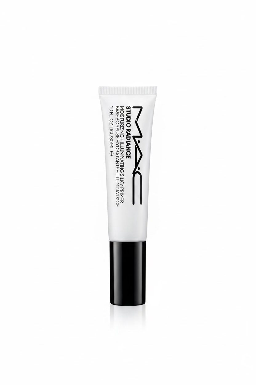 A tube of MAC Studio Radiance Moisturizing Silk Primer standing upright on a glass display counter inside a retail store. The product tube is white with black text and a black cap, with MAC branding clearly visible.