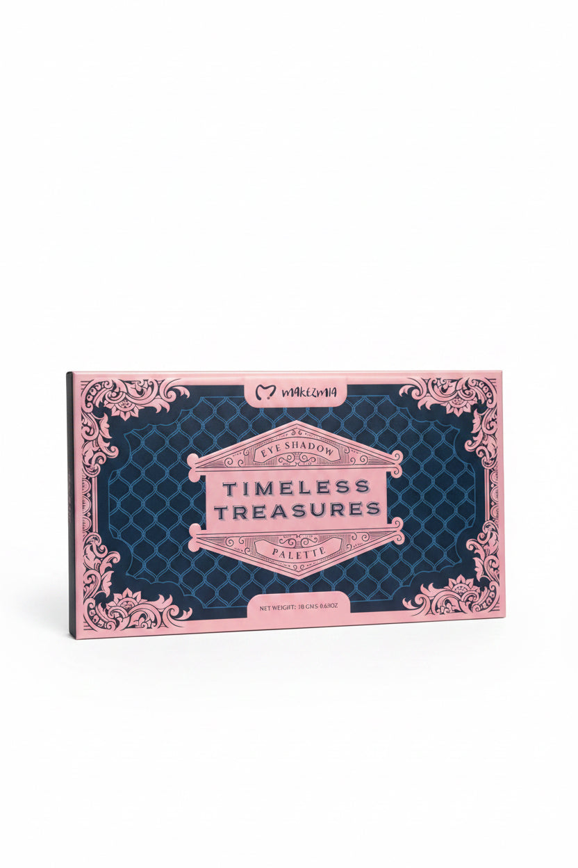 A person holds a pink and navy blue eyeshadow palette in a retail store. The palette features ornate pink filigree borders and the text 'TIMELESS TREASURES PALETTE' on the front.