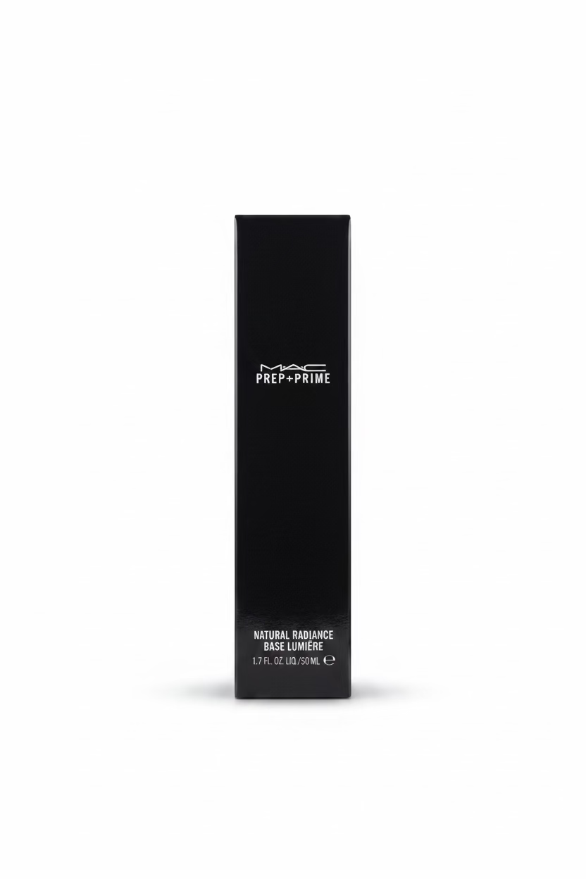 A black rectangular box of MAC Prep+Prime Natural Radiance Base Luminére, standing on a glass display counter inside a retail store.