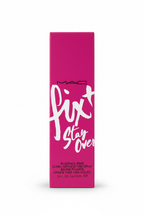A pink rectangular box of MAC Fix Stay Over Alcohol-Free Long Acting Setting Spray, displayed on a glass shelf in a retail store.
