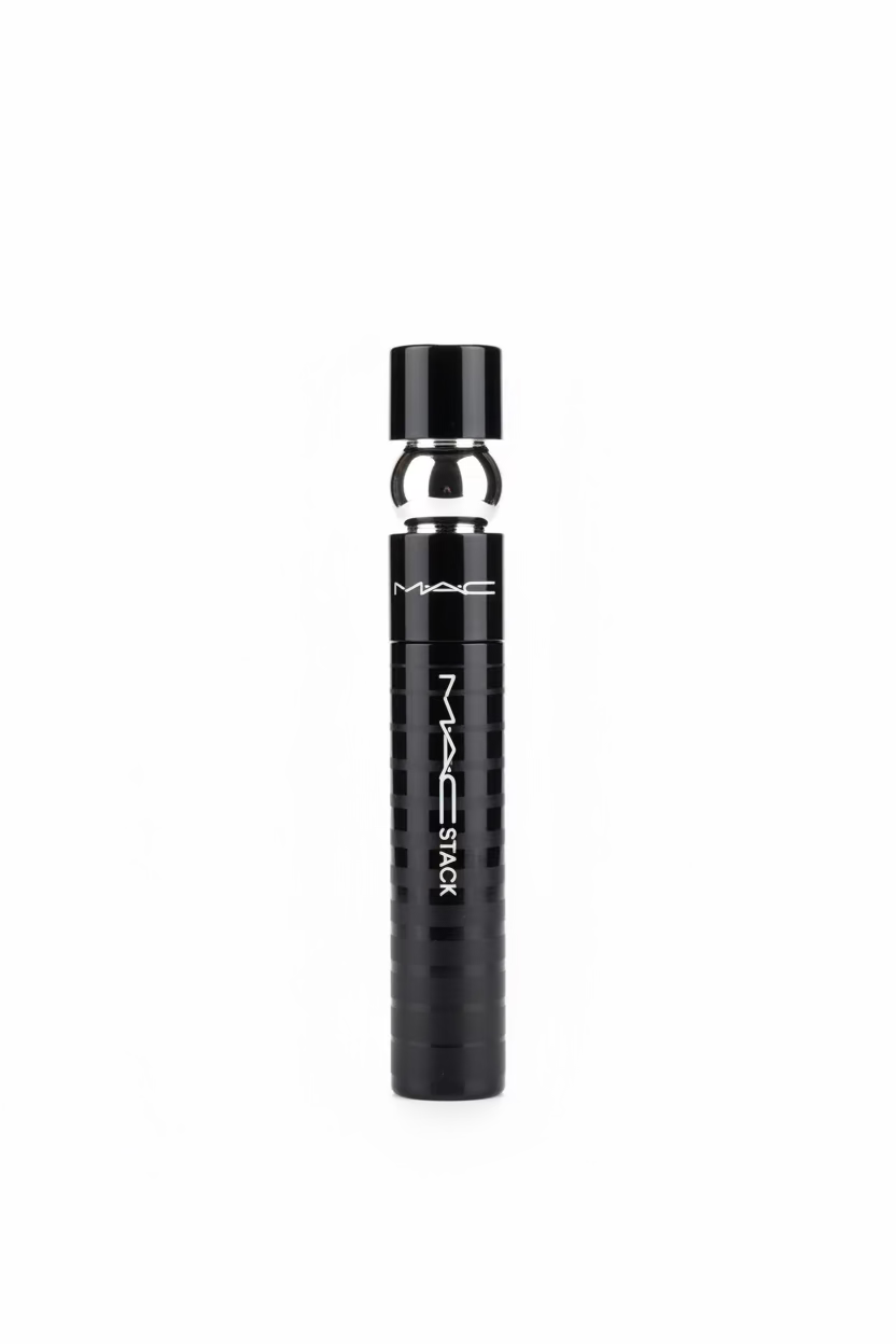 A black MAC Stack perfume bottle with a silver metallic neck, displayed on a glass counter inside a retail store.