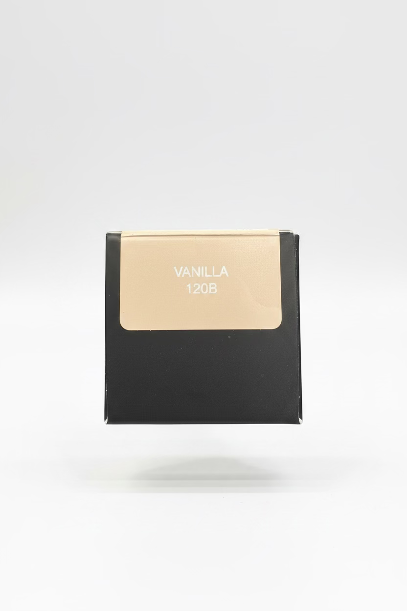 A hand holding a small black box with a beige label that reads 'VANILLA 120B' in a casual indoor setting.