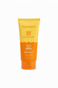 A tube of Aqualogica Glow Dewy Gel Sunscreen SPF 50+ standing on a laptop desk in a shop setting.