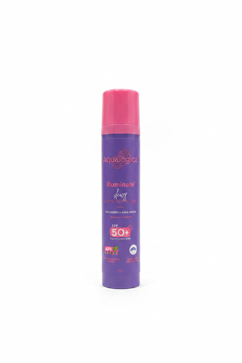 A bottle of Aqualogic Illuminate Dewy Sunscreen Gel SPF 50+ with a purple body and pink cap, standing on a glass display counter in a retail store.