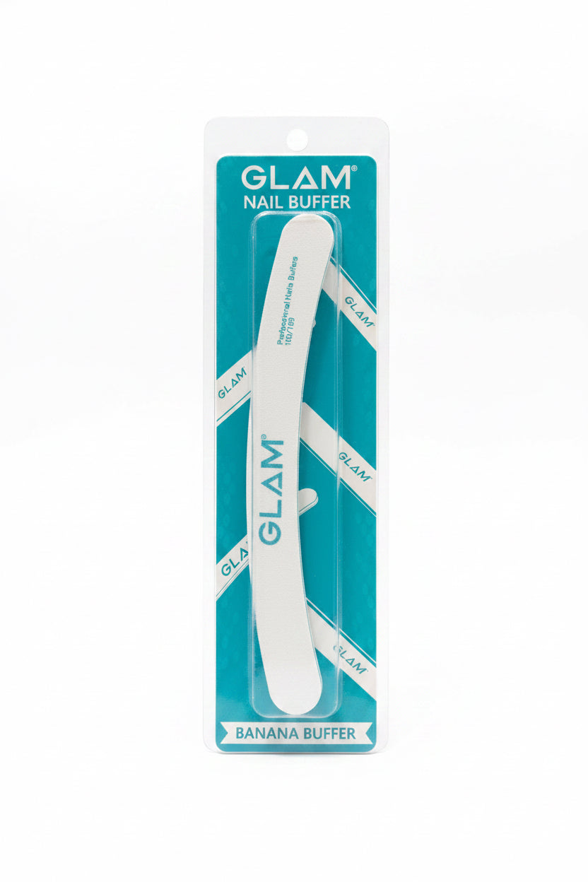 A packaged Glam Nail Buffer labeled Banana Buffer, standing in front of two laptop screens. The product is in its original teal and white blister packaging, with the white nail file visible inside.