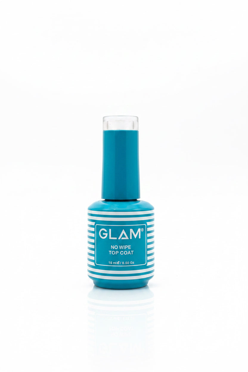 A bottle of GLAM No Wipe Top Coat nail polish in a teal blue shade, standing on a light gray tabletop with an open laptop in the background.