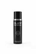 A black Glam Pro Range acrylic liquid bottle wrapped in clear plastic, standing on a desk next to an open laptop in an office setting.