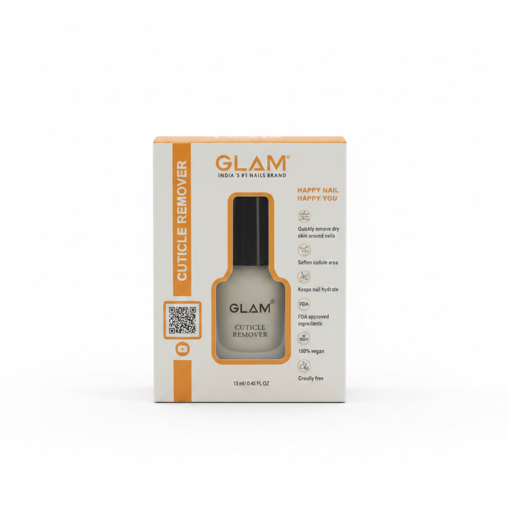 GLAM Cuticle Remover in its original white and orange retail box, placed on top of a silver laptop on a desk with a computer monitor and office items in the background.