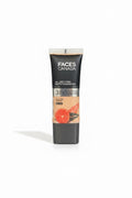 A hand holding a tube of Faces Canada 3-in-1 All Day Hydra Matte Foundation SPF 30, set against a background of blue denim jeans.