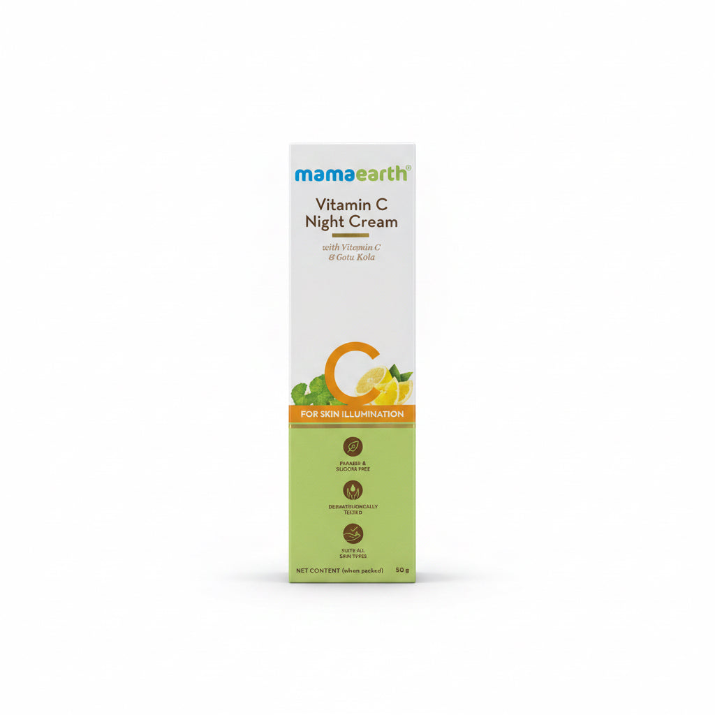 A box of Mama Earth Vitamin C Night Cream stands on a counter in a retail or office setting, with a teal basket, other skincare items, and a laptop visible in the background.
