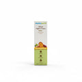 A box of Mama Earth Ubtan Night Cream stands upright on a desk in front of an open laptop. The packaging is cream and light green with orange and yellow accents, and the brand name 'mamaearth' is clearly visible at the top.