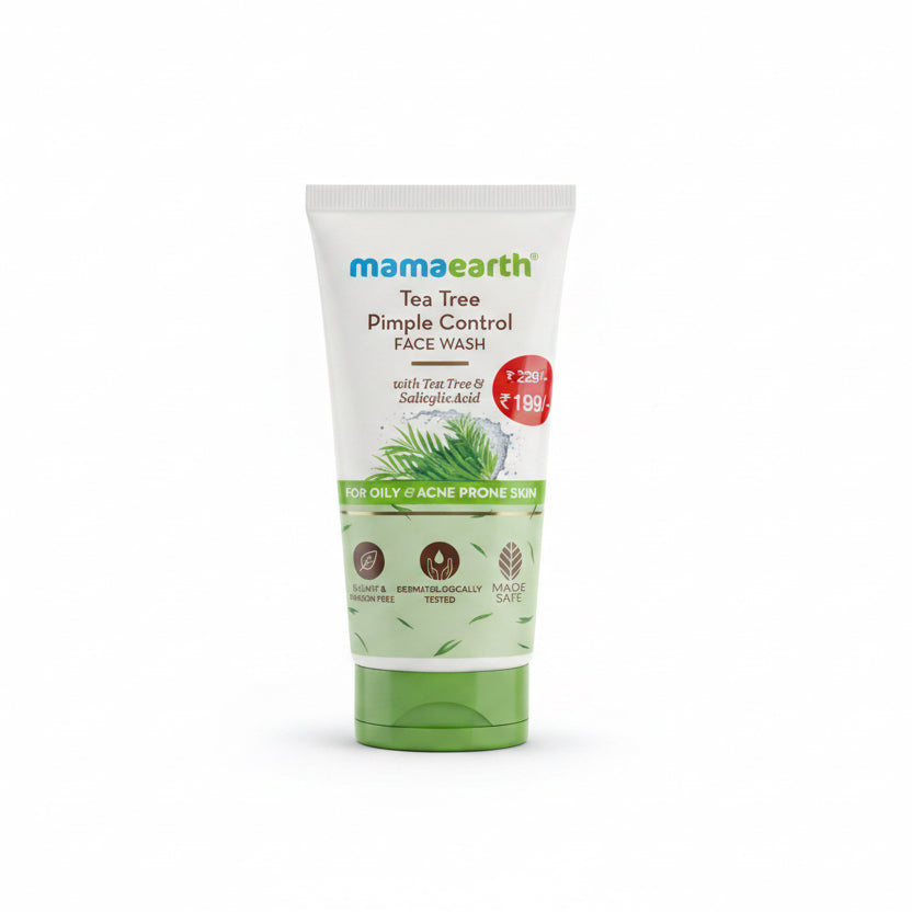 A tube of Mamaearth Tea Tree Pimple Control Face Wash standing on a laptop keyboard in an office setting, with a desk, chair, and keyboard visible in the background.