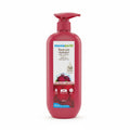 A 400 ml bottle of Mama Earth Beetroot Hydraful Body Lotion in a bright pink bottle with a red pump dispenser, placed on a wooden table in an indoor setting.