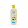 A bottle of Mama Earth Vitamin C Daily Glow Body Lotion with a yellow pump dispenser, placed on a dark tabletop in an indoor setting.
