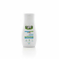 A bottle of Mamaearth Baby Milky Soft Body Lotion is shown on a desk in front of a laptop, with Mamaearth product boxes in the background.