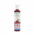 A bottle of Mama Earth Onion Hair Fall Control Conditioner with a white pump dispenser, standing on a white surface with a blurred laptop in the background.