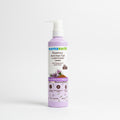 A bottle of Mama Earth Rosemary Anti-Hair Fall Conditioner placed on a laptop on a desk, with a blurred home office background.