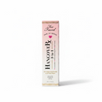Too Faced Hangover Rx 3-in-1 Replenishing Primer & Setting Spray in a tall pink box, displayed on a glass counter with a blurred cosmetics store background.