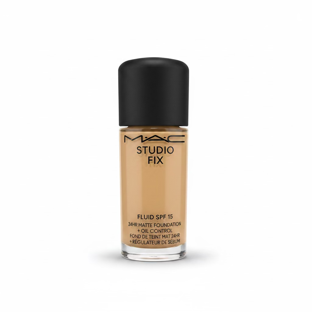A bottle of MAC Studio Fix Fluid SPF 15 liquid foundation with a black cap, displayed on a glass counter in a store setting with a laptop blurred in the background.