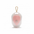 A pink heart-shaped makeup sponge inside a clear plastic hanging case with a beige loop, displayed on a glass counter in a store setting.